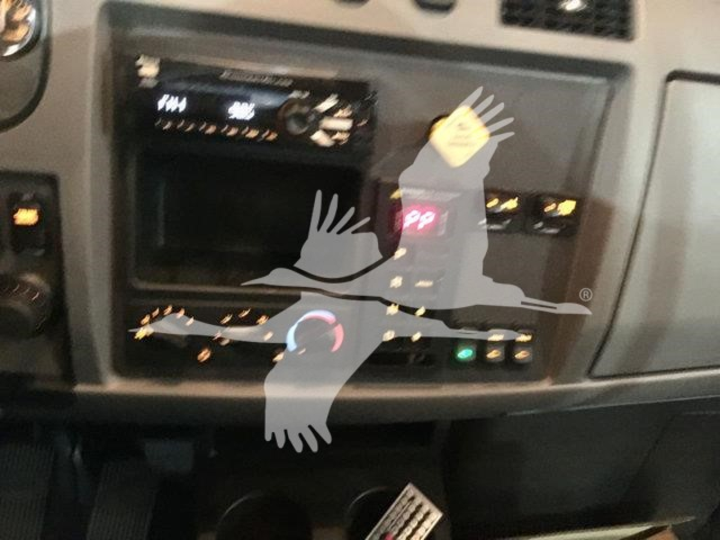 Peterbilt 337 dash area showing radio and climate controls with badges and sticker overlay.
