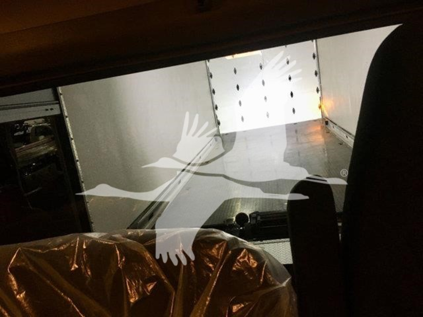 Peterbilt 337 cab interior view showing truck bed and rear doors with interior lights.