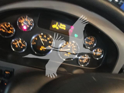 Dashboard gauges of a 2022 Peterbilt 337 showing multiple analog dials and warning lights.