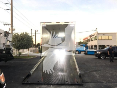 Truck trailer with an open rear ramp, loading dock area, Peterbilt 337 listing context in background.