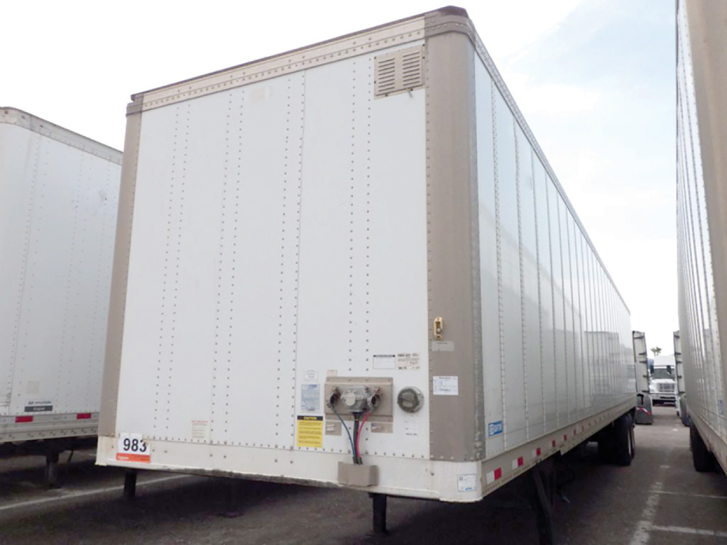 Trailer rear and side view showing a white 2019 Stoughton Z-Plate dry van trailer with rear bumper and registration numbers visible.