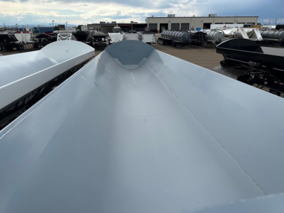Close-up of a silver Jet Air Ride Side Dump trailer roof showing smooth curved surface and raised center peak.