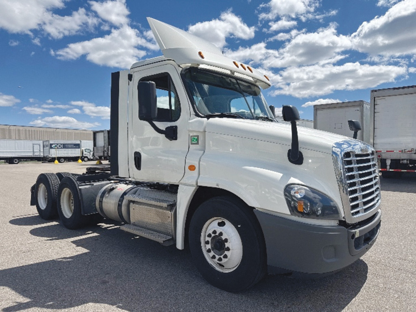 Truck showing Freightliner Cascadia125 daycab front-left-quarter view with white cab and chrome grille.