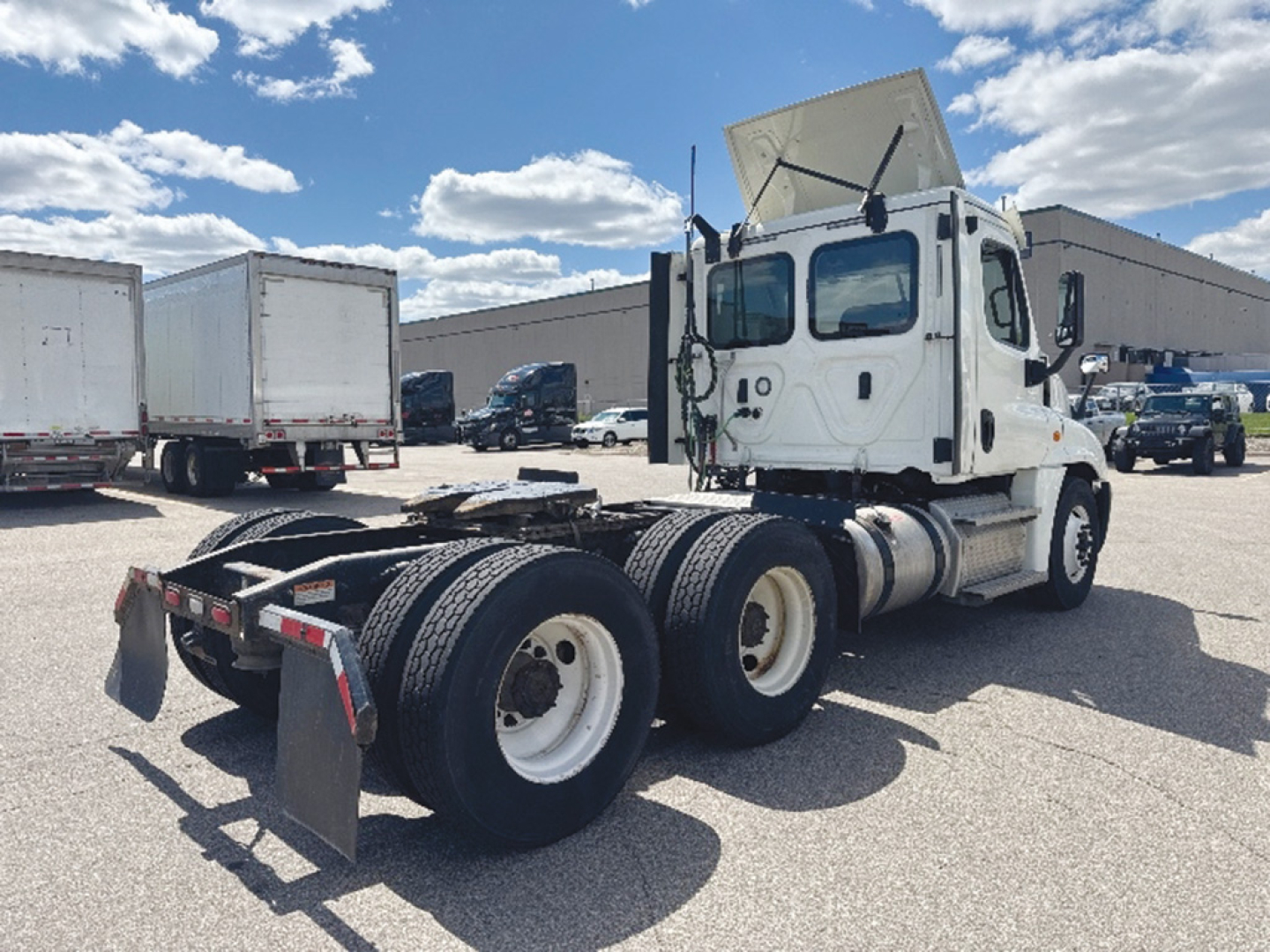 2020 Freightliner Cascadia125 tractor viewed from rear passenger side showing dual rear axles and fifth wheel missing.