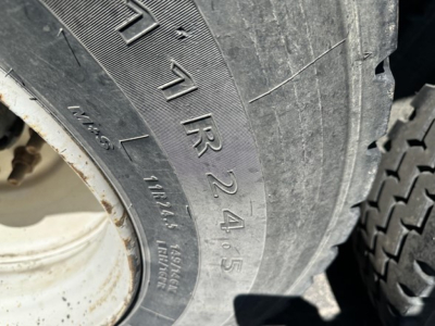 Tire sidewall close-up on a dump trailer showing 17.5R245 tire size and related markings.