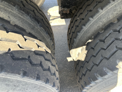 Trailer axle tires close-up showing dual axles and tread patterns for a 2015 unknown 40' air ride bottom dump trailer.