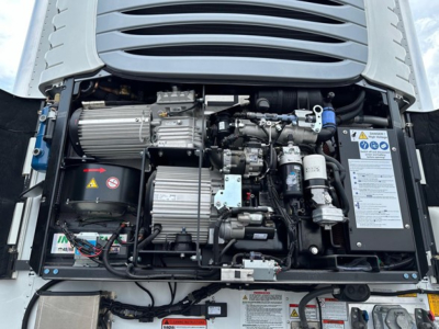 Reefer trailer engine bay of a 2027 Utility Cargo Bull 625 Hybrid showing engine components and labels.