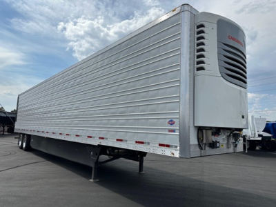 Reefer trailer with Camara refrigeration unit at front showing Ribbed aluminum side panels and landing gear.