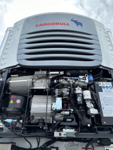 Cargobull trailer front engine bay with visible components and a badge reading CARGOBULL on the grille.