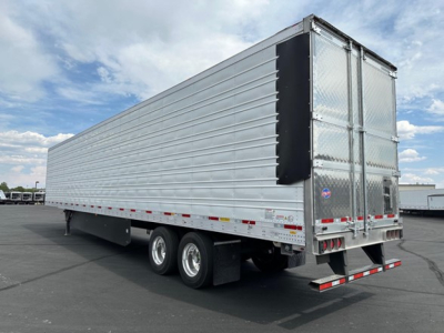 Utility trailer rear-right view showing tandem axles and aluminum riveted side panels with rear double doors.