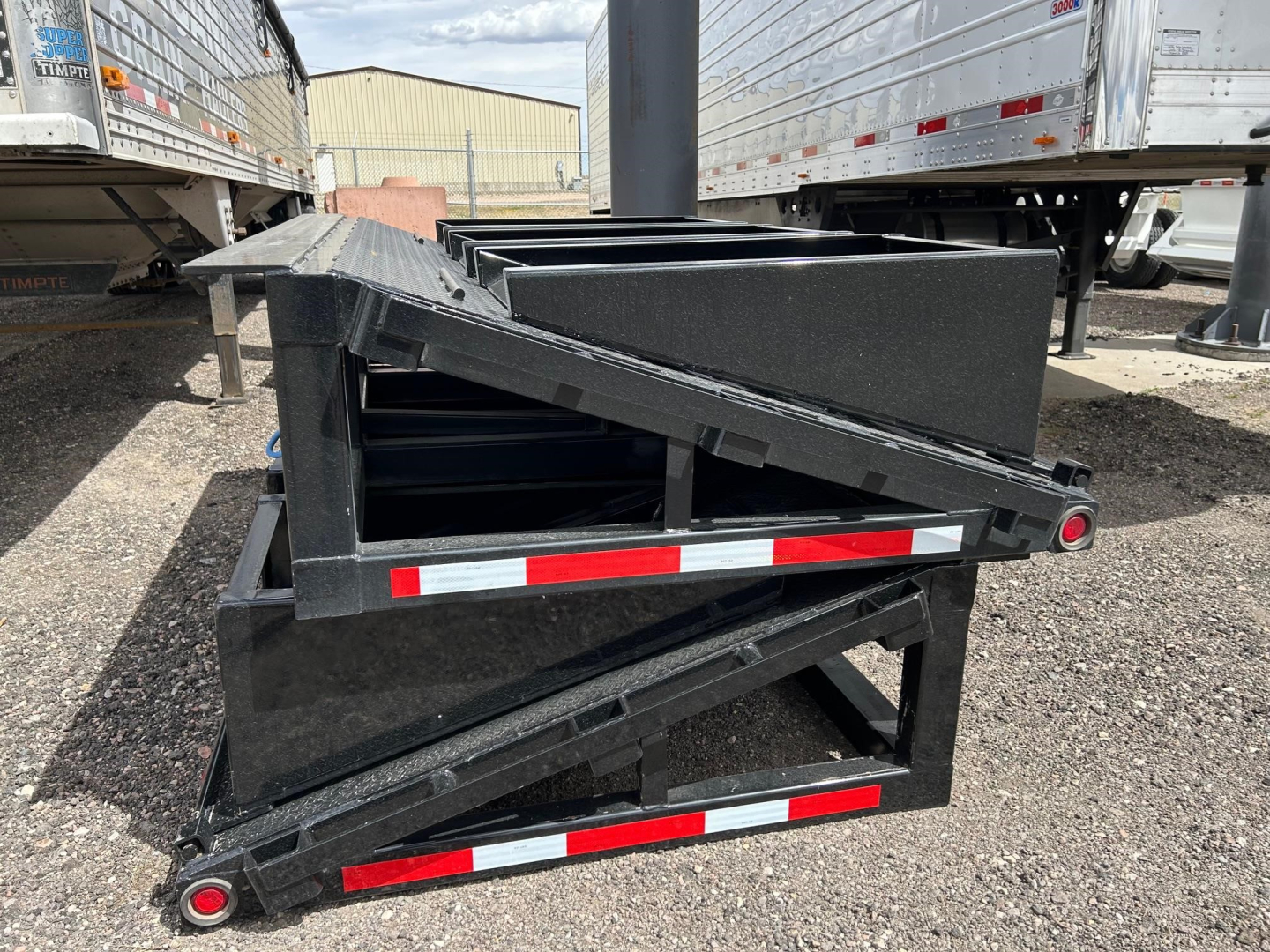 Neville Beaver Tail W 3 Flip Ramps trailer component with folded ramps and red-white reflective stripes.