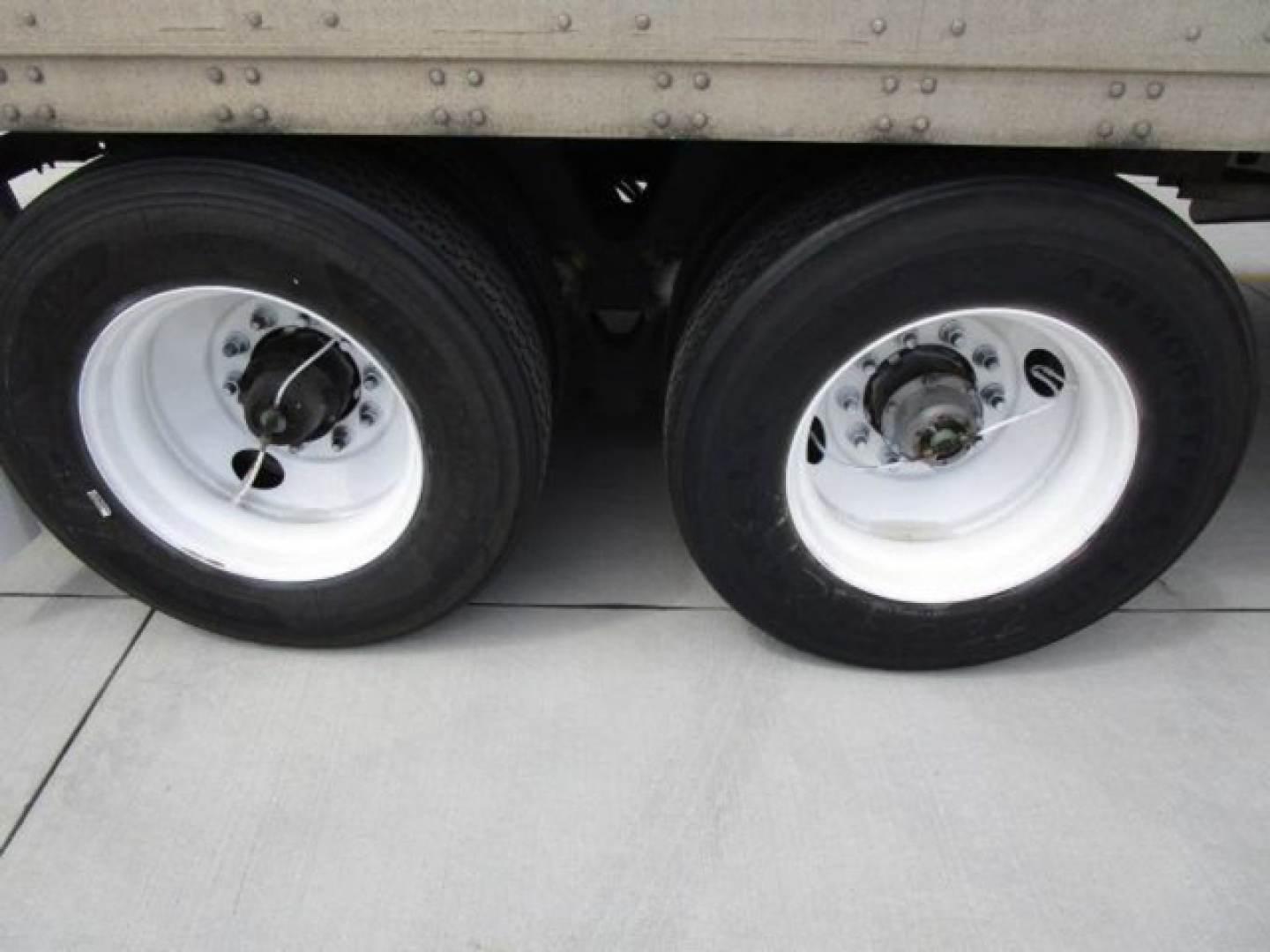 Stoughton van dual rear wheels showing white rims and black tires under the trailer side