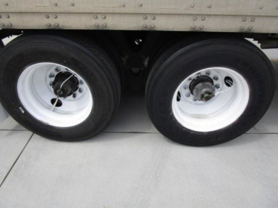 Stoughton van dual rear wheels showing white rims and black tires under the trailer side