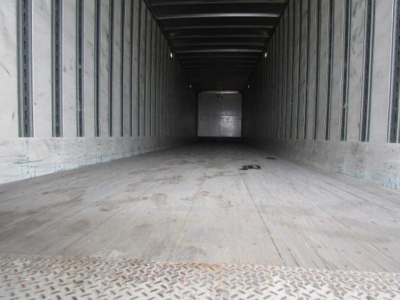 Stoughton van trailer interior showing empty cargo space with wooden floor and metal sidewalls, lengthy rectangular trailer interior perspective.