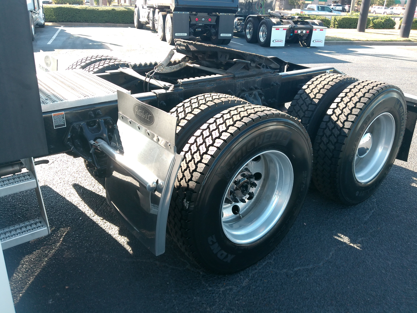 Peterbilt 579 tractor rear dual axle wheels and chassis showing fifth wheel area and tires.
