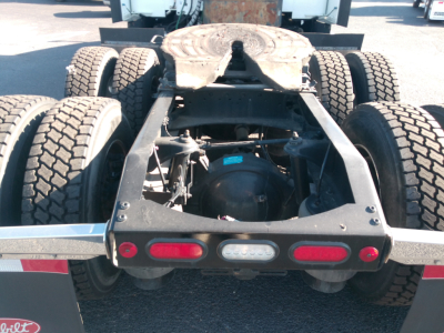 Peterbilt 579 rear chassis view showing tandem axle setup, fifth wheel, frame rails, and rear lights.