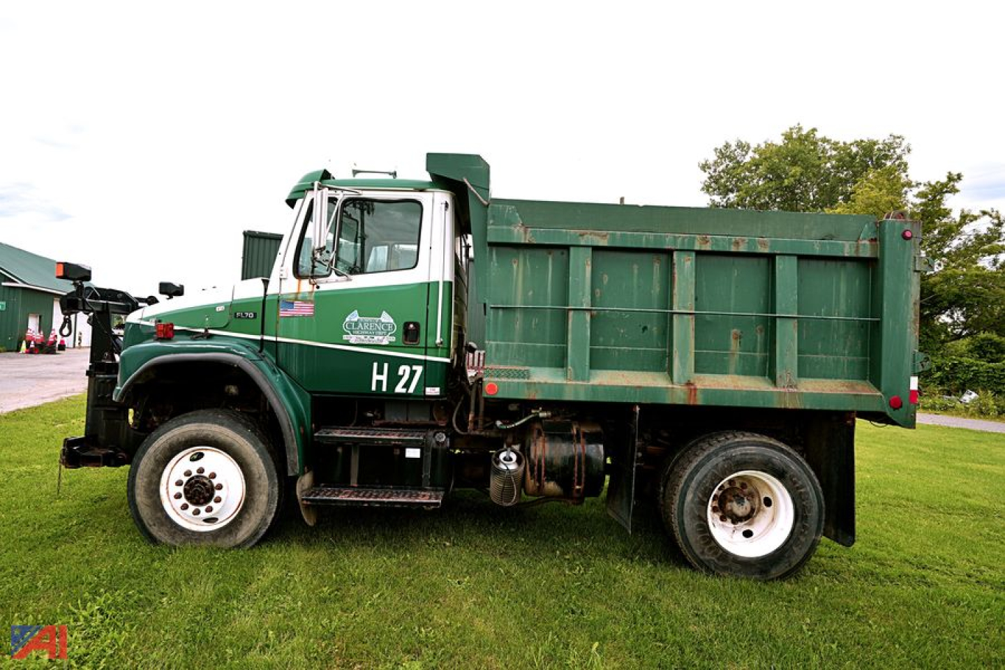 Dump truck side view showing green Freightliner F70 with dump bed and H27 designation.