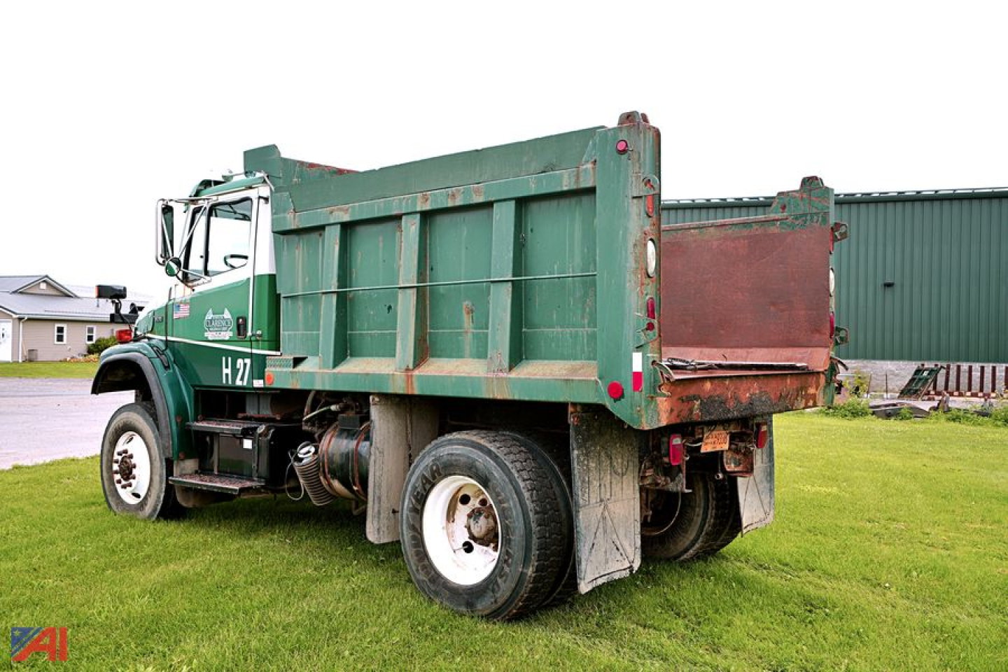 Dump truck body with green cab and H27 designation on door, Freightliner F70 model, side view showing dump bed and plow truck configuration.