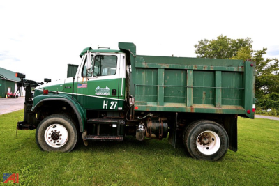 Dump truck side view showing green Freightliner F70 with dump bed and H27 designation.