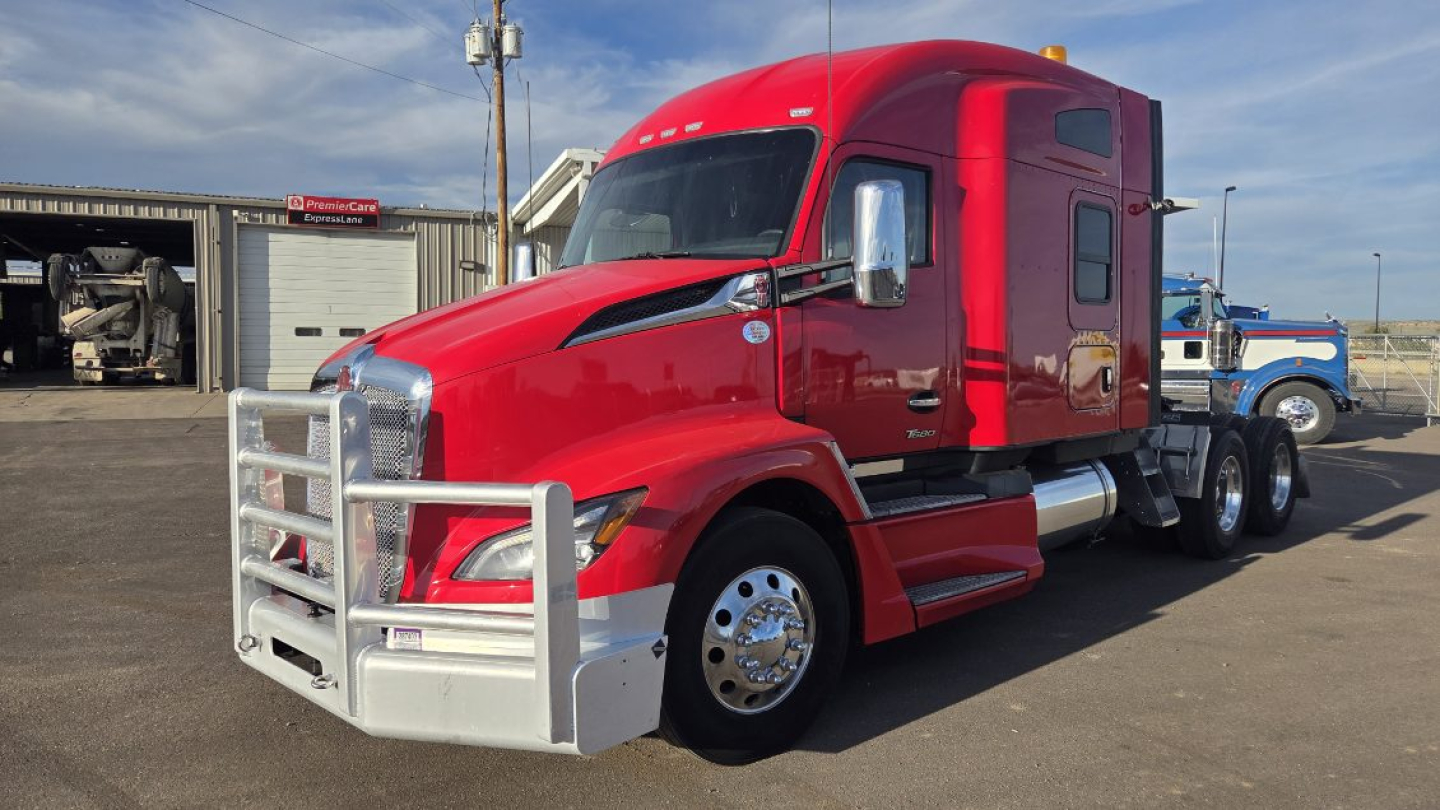 Kenworth T680 tractor-trailer in red, front bull bar guard, chrome grille, sleeper cab, dual rear axles, chrome mirrors.