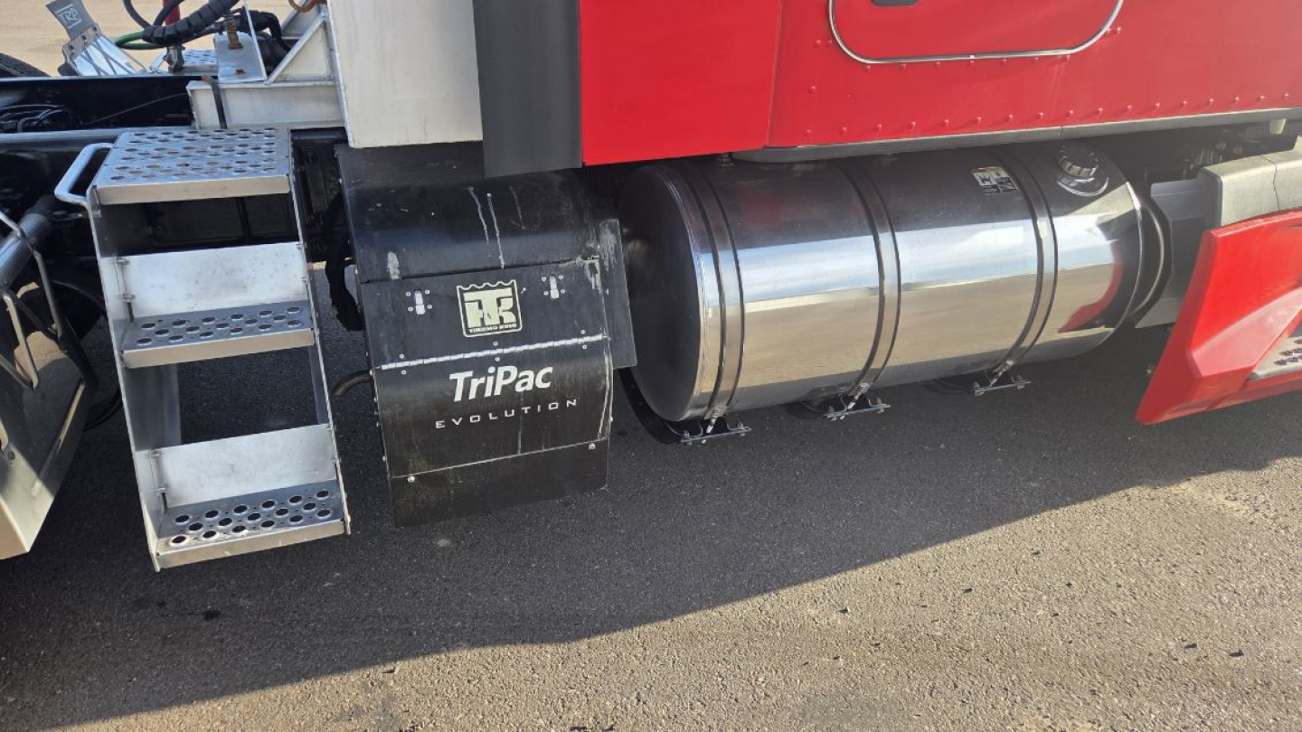 Kenworth T680 truck side showing fuel tanks and TriPac Evolution cooling unit under the cab.