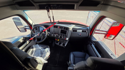 Kenworth T680 truck interior view showing driver seat, steering wheel, dashboard, and front cab area.