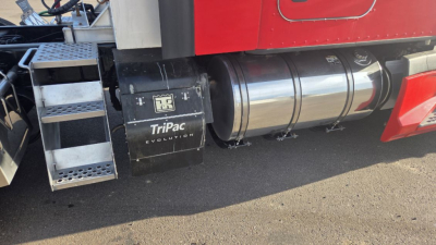 Kenworth T680 truck side showing fuel tanks and TriPac Evolution cooling unit under the cab.