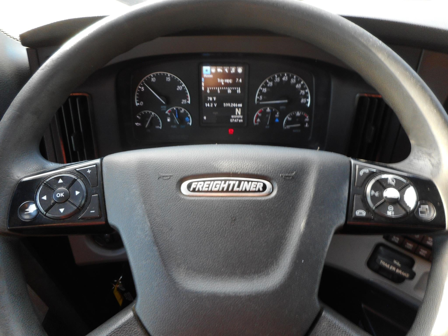 Volvo? No Freightliner steering wheel with dashboard gauges; center screen; left and right control panels visible.