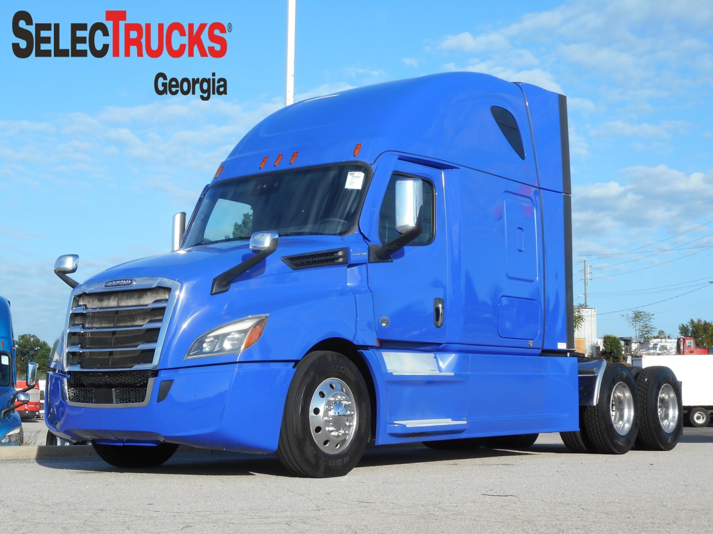 Freightliner Cascadia 126 truck in blue, side view, in-use condition with SelectTrucks Georgia branding; VIN plate not visible.