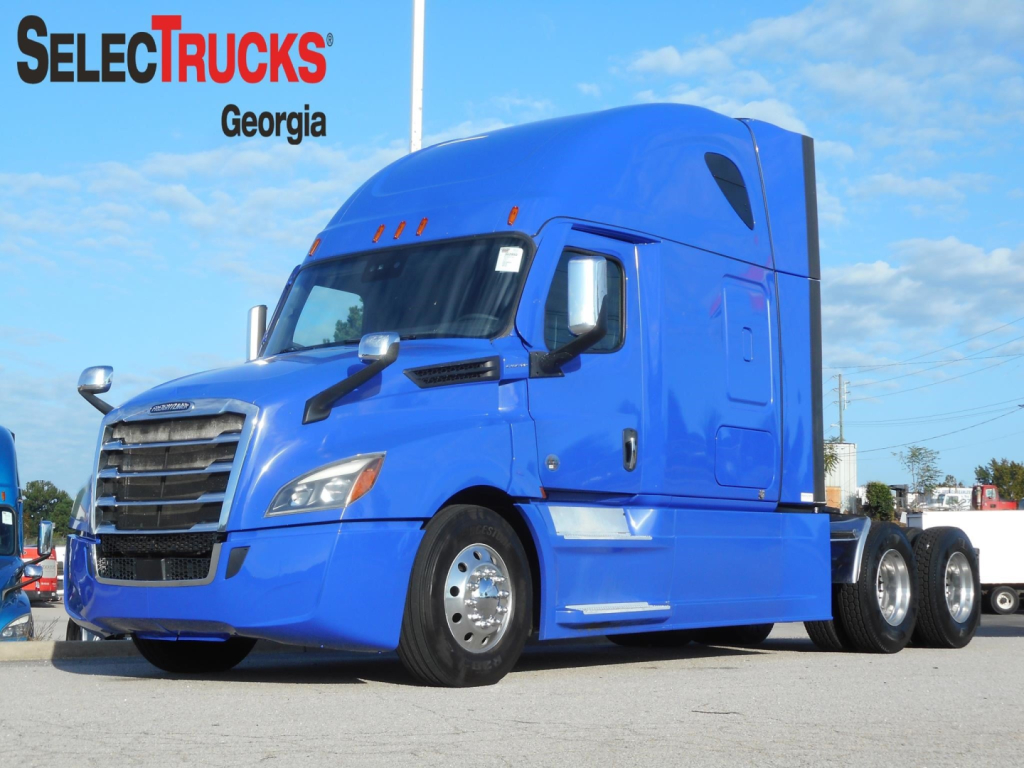 Freightliner Cascadia 126 truck in blue, side view, in-use condition with SelectTrucks Georgia branding; VIN plate not visible.