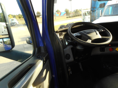 Cab interior of a 2022 Freightliner Cascadia 126 truck showing steering wheel and dashboard from doorway view.