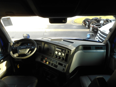Interior of a 2022 Freightliner Cascadia 126 sleeper cab showing dashboard with steering wheel, digital gauges, and control panels.