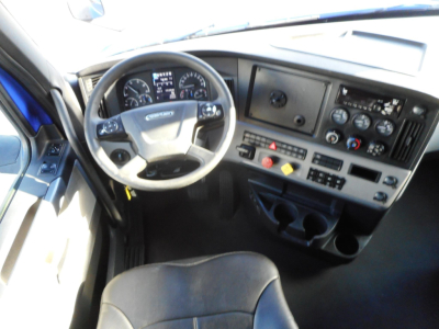 Dashboard and steering wheel of a 2022 Freightliner Cascadia 126 truck interior showing gauges, steering wheel, and control panel.