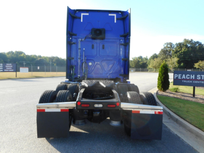Freightliner Cascadia 126 rear view showing fifth wheel, dual rear axles, and mud flaps.