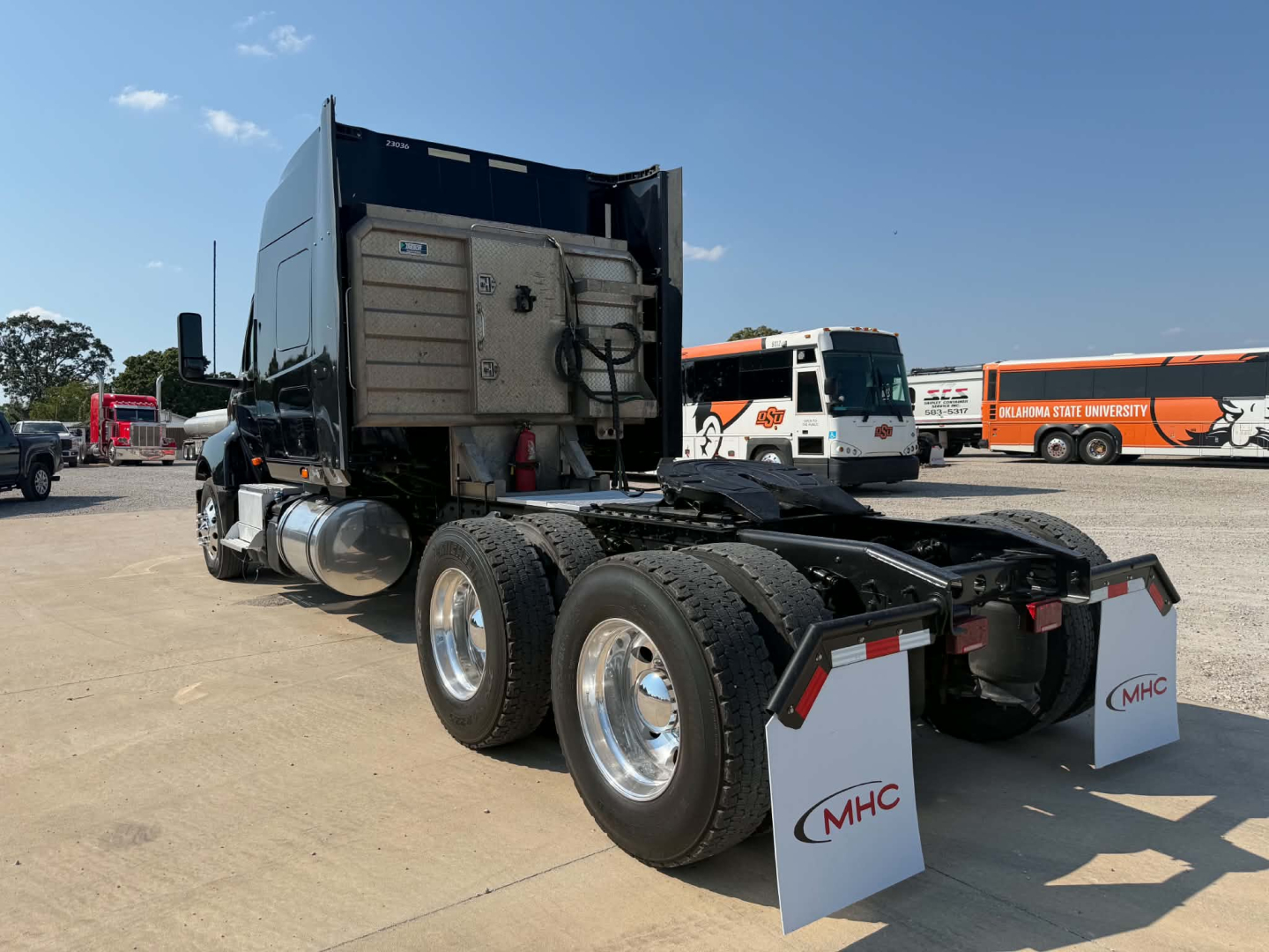 Truck cab and dual rear axles of a used 2023 International LT625 tractor shown from rear-left angle.