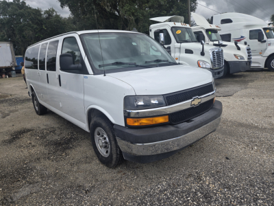 Chevrolet Express 3500 passenger van side/front view showing white body, black grille, and Chevrolet emblem.