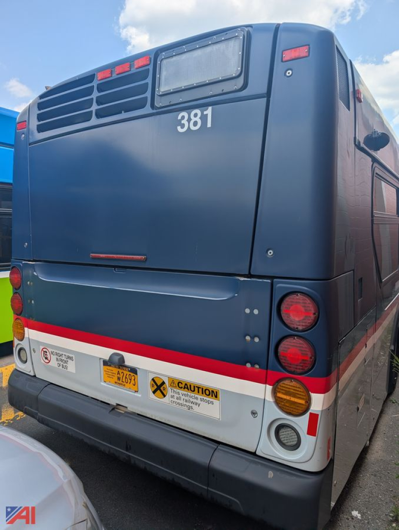 Bus rear view of 2013 New Flyer Xcelsior transit bus with number 381, taillights, and warning sticker on white lower panel.