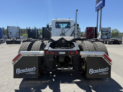 Truck rear view of a 2027 Mack PI84T tractor with two large rear tires, mud flaps labeled Bruckner's Truck & Equipment, and fifth wheel mounting.