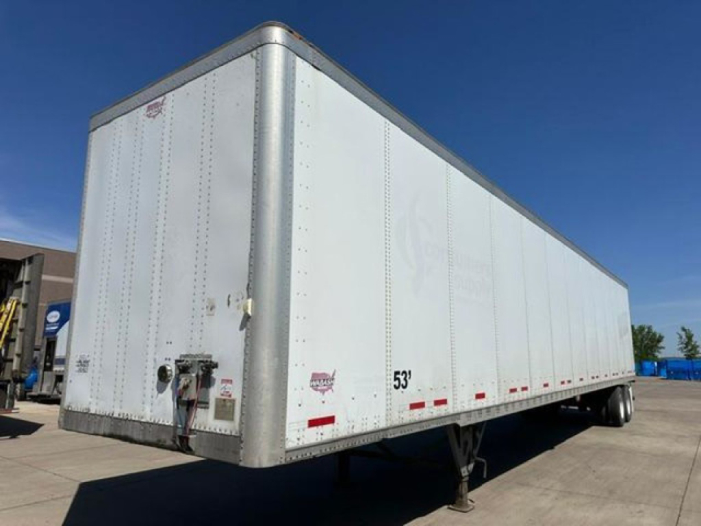 Trailer side view showing 53' Wabash box truck trailer with rear hitch, landing gear, and DOT markings.