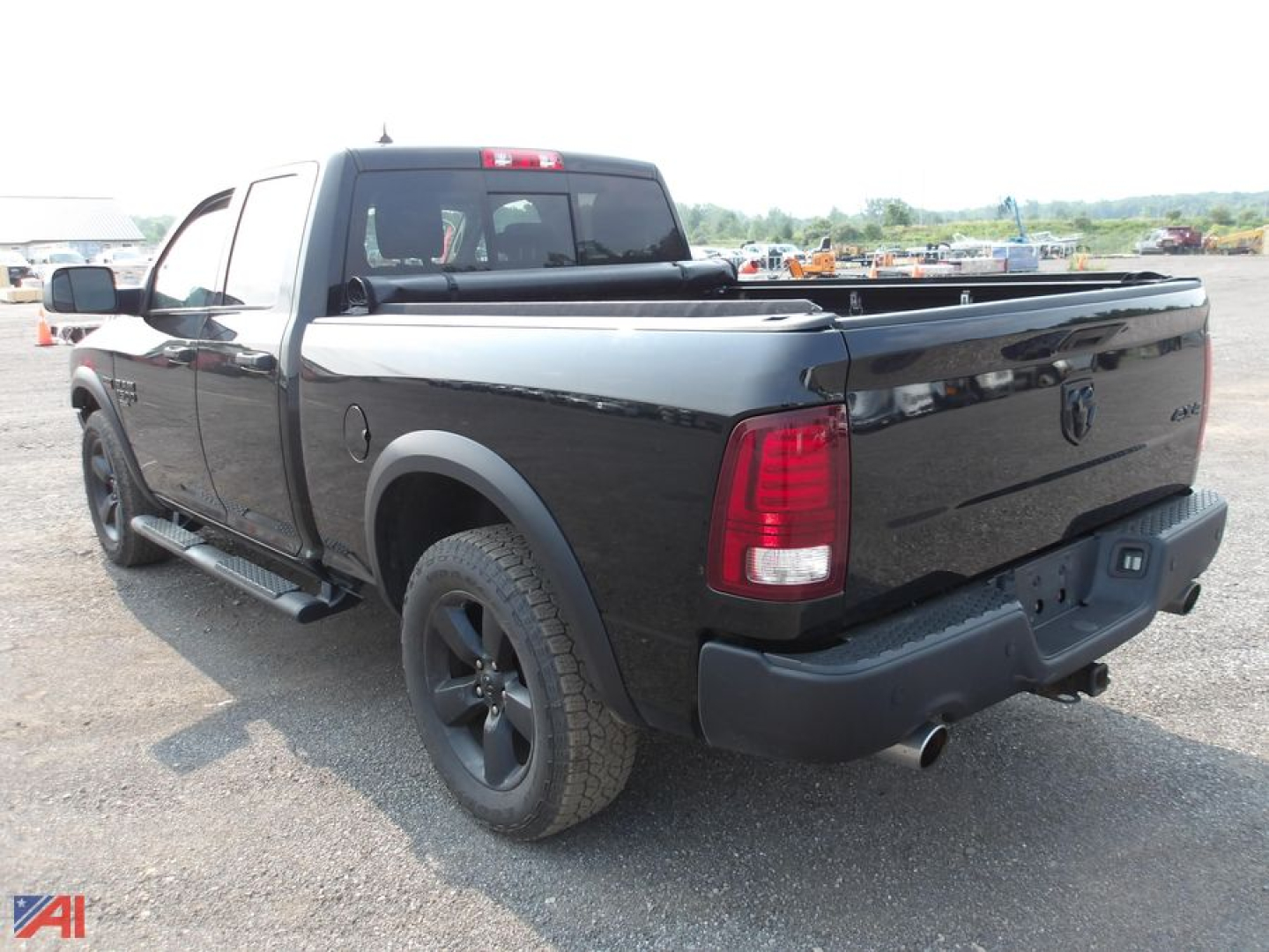Ram 1500 Classic Crew Cab pickup truck rear quarter view showing bed cover and taillights.