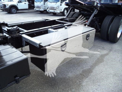 Truck chassis with large aluminum toolbox mounted beside rear axle of a 2019 Freightliner M2 106 rollback truck.