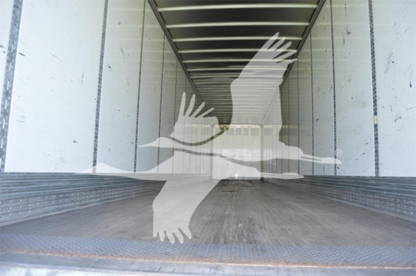 Trailer interior showing empty cargo box with Wabash logo watermark overlay.