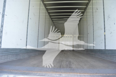 Trailer interior showing empty cargo box with Wabash logo watermark overlay.