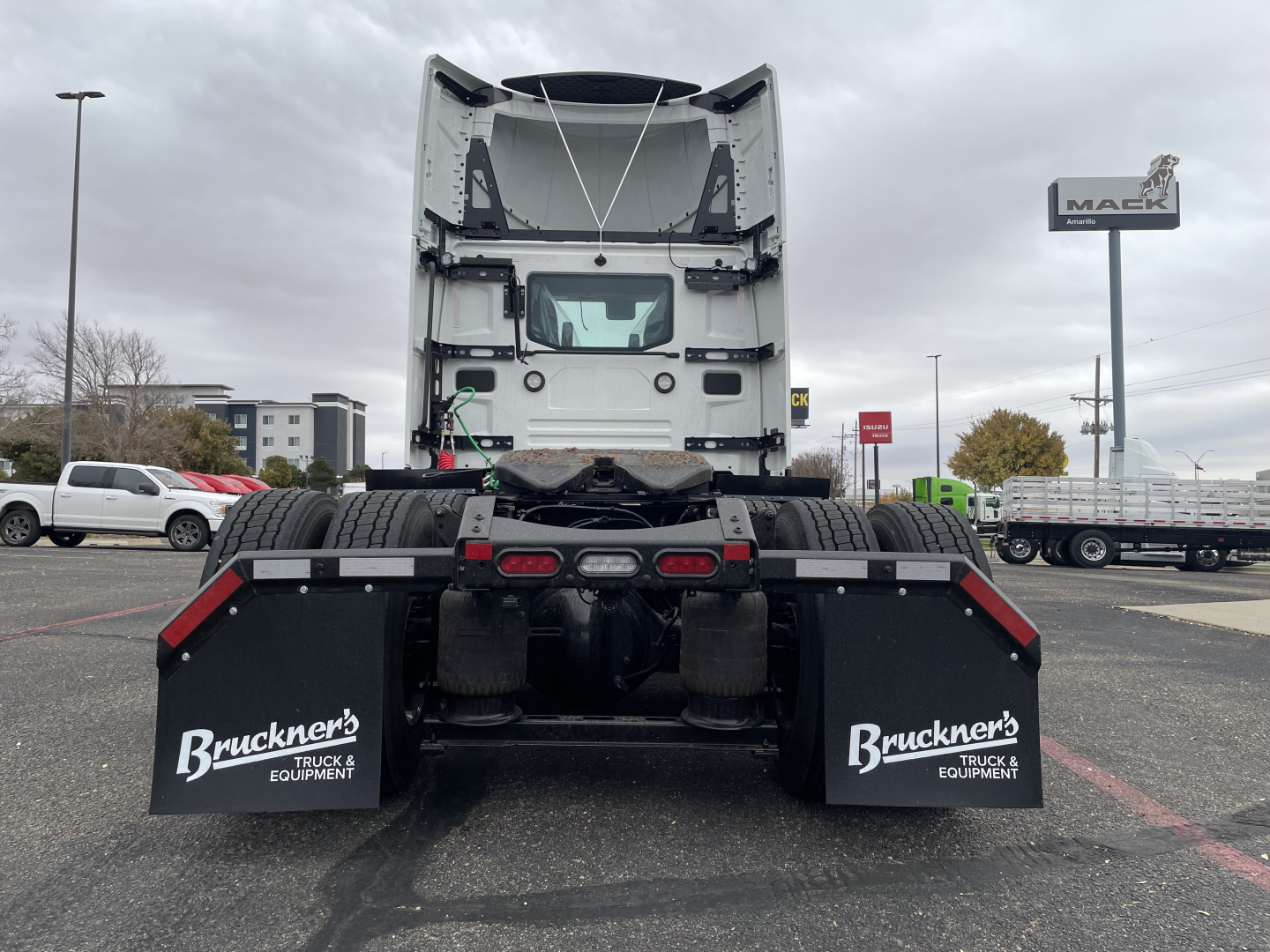 Tractor trailer rear view with fifth wheel and dual rear axles, mud flaps labeled 'Bruckner's TRUCK & EQUIPMENT' on both sides.