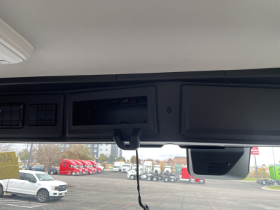 Forward view inside Mack PR64T truck cab showing instrument panel excerpt and overhead area.