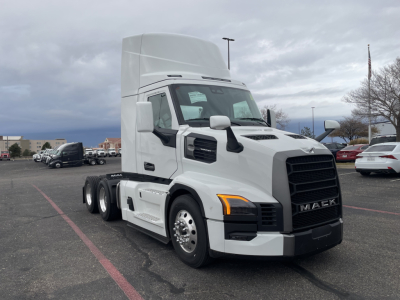 Mack PR64T conventional daycab tractor shown in white, cab-forward with high sleeper, large black front grille, dual rear axles, and side mirrors.