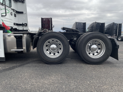 Mack PR64T truck chassis showing dual rear axles with polished wheel hubs and tires, side view of cab, fuel tanks, and undercarriage components.