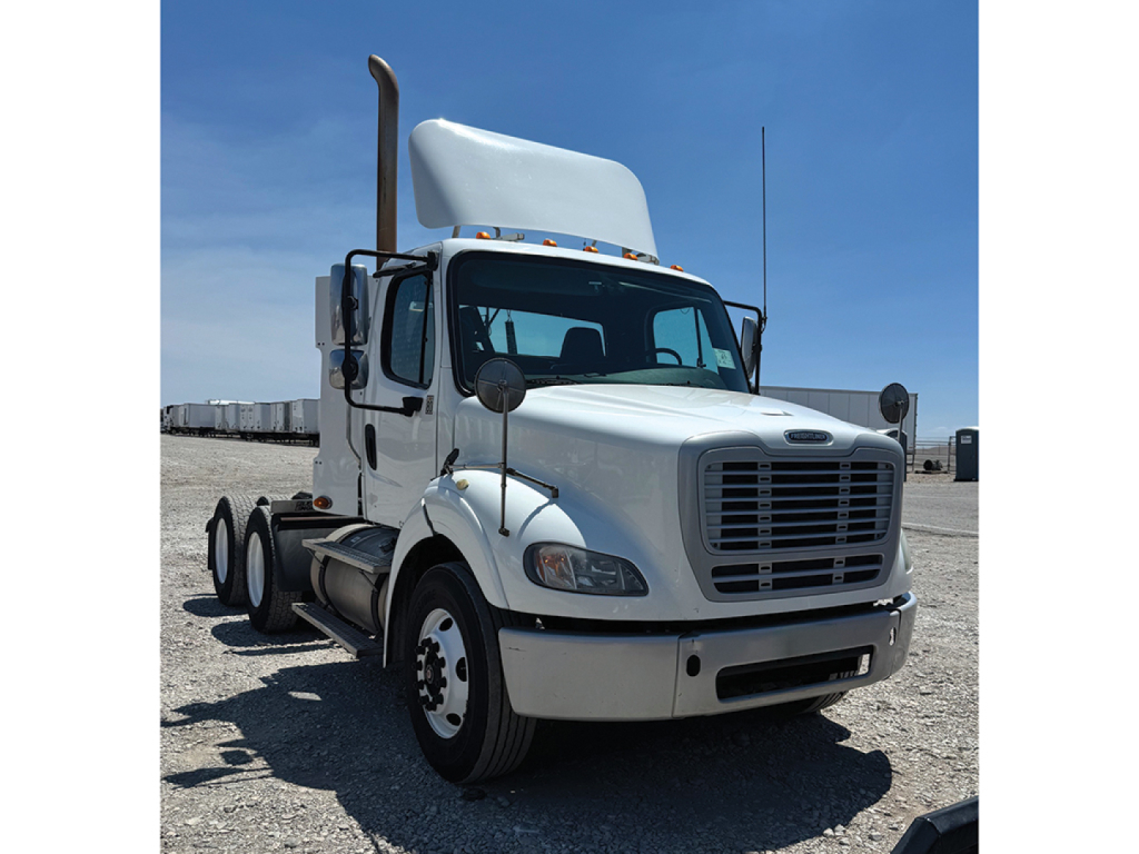 Truck cab showing front grille and headlights with tall exhaust stack on Freightliner M2-112 daycab