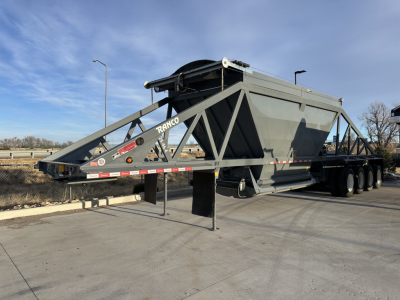 Ranco LW24464 trailer dumping scow showing heavy steel frame and dual-axle configuration with reflective tape.