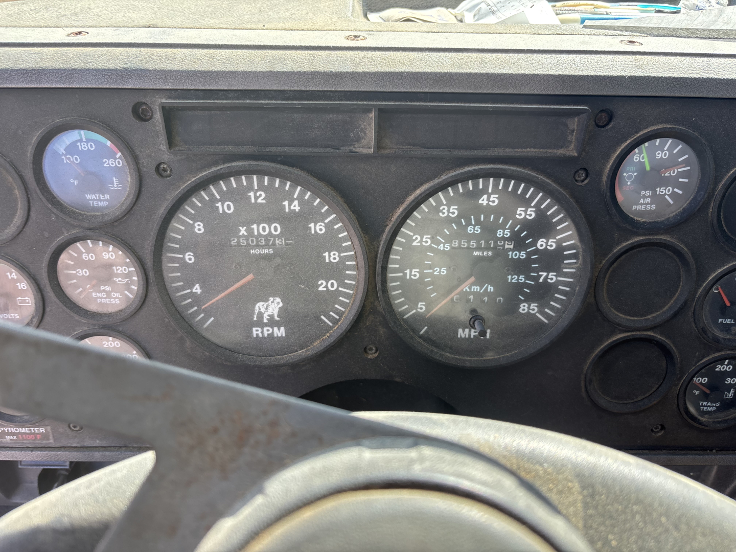 Mack CH613 dashboard gauges showing tachometer, speedometer, and auxiliary gauges in an in-service truck cab repair photo.